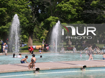 People are cooling off in the water on Centre Island on a hot day in Toronto, Ontario, Canada, on July 13, 2024. (