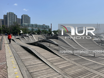 A wavy walkway is appearing at Harbourfront in Toronto, Ontario, Canada, on July 13, 2024. (