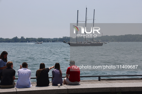 People are admiring boats along Harbourfront in Toronto, Ontario, Canada, on July 13, 2024. 