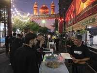 A worshipper is drinking donated tea during a religious rally to commemorate Tasoua in the Dolatabad neighborhood in southern Tehran, Iran,...