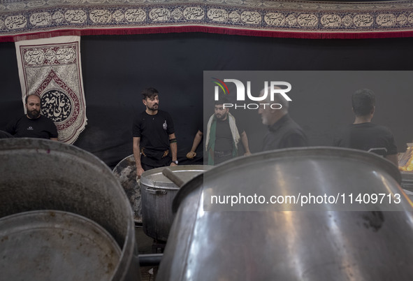 Iraqi men living in Iran are preparing donated meals for worshippers during a religious rally to commemorate Tasoua, in Dolatabad neighborho...