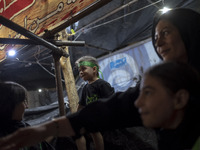 A young boy is wearing a religious headband while participating with his family in a religious rally to commemorate Tasoua, in Dolatabad nei...