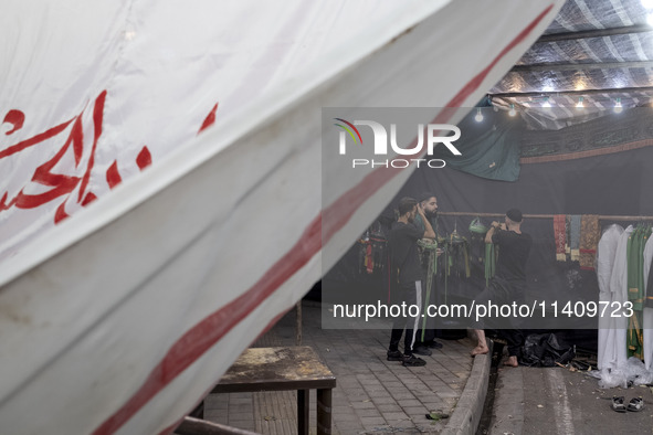 Iraqi men living in Iran are preparing to perform in a religious rally to commemorate Tasoua, in Dolatabad neighborhood in southern Tehran,...