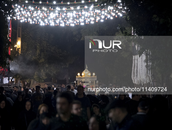 A religious symbol is being pictured during a religious rally to commemorate Tasoua in the Dolatabad neighborhood in southern Tehran, Iran,...