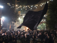 A young boy is being carried by his father during a religious rally to commemorate Tasoua, in Dolatabad neighborhood in southern Tehran, Ira...