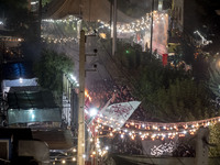 An Iraqi worshipper living in Iran is carrying a religious flag during a religious rally to commemorate Tasoua in the Dolatabad neighborhood...