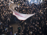 An Iraqi worshipper living in Iran is waving a religious flag during a religious rally to commemorate Tasoua, in Dolatabad neighborhood in s...