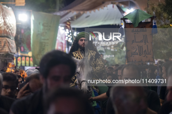 An Iraqi man living in Iran is riding a horse while performing in a religious rally to commemorate Tasoua, in Dolatabad neighborhood in sout...