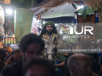 An Iraqi man living in Iran is riding a horse while performing in a religious rally to commemorate Tasoua, in Dolatabad neighborhood in sout...