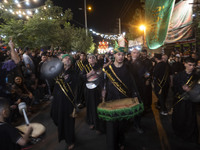 Iraqi worshippers living in Iran are performing in a religious rally to commemorate Tasoua in the Dolatabad neighborhood in southern Tehran,...