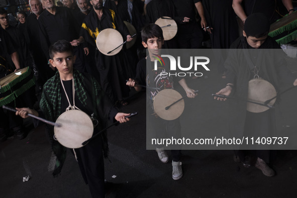 Iraqi young boys living in Iran are performing in a religious rally to commemorate Tasoua, in Dolatabad neighborhood in southern Tehran, Ira...