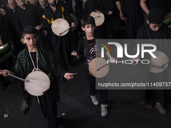 Iraqi young boys living in Iran are performing in a religious rally to commemorate Tasoua, in Dolatabad neighborhood in southern Tehran, Ira...