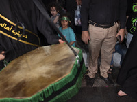 A young girl is wearing a religious headband and is participating in a religious rally to commemorate Tasoua in Dolatabad neighborhood in so...