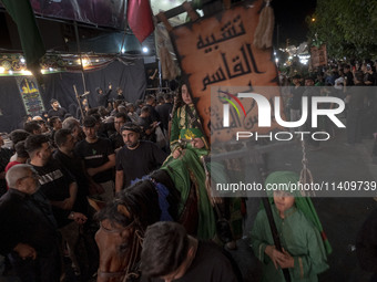 A young Iraqi boy living in Iran is riding a horse while performing in a religious rally to commemorate Tasoua, in Dolatabad neighborhood in...