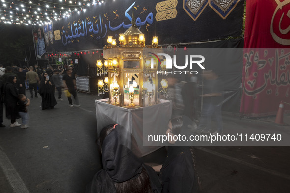 A religious symbol is being pictured during a religious rally to commemorate Tasoua in the Dolatabad neighborhood in southern Tehran, Iran,...