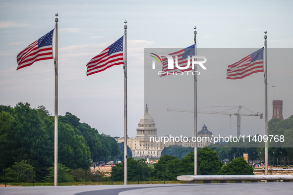 A view on the U.S. Capitol building and American flags by Washington Monument in Washington, DC in the United States of America on July 9th,...