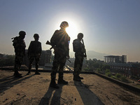 Indian paramilitary soldiers are keeping vigil from the top of a building as thousands of Shia Muslims are attending the mourning procession...