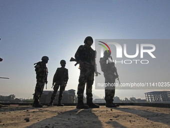 Indian paramilitary soldiers are keeping vigil from the top of a building as thousands of Shia Muslims are attending the mourning procession...