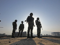 Indian paramilitary soldiers are keeping vigil from the top of a building as thousands of Shia Muslims are attending the mourning procession...