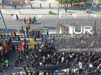 Thousands of Shia Muslims are attending the mourning procession to commemorate the martyrdom of Prophet Muhammad's grandson Imam Hussein (Hu...