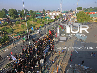 Thousands of Shia Muslims are attending the mourning procession to commemorate the martyrdom of Prophet Muhammad's grandson Imam Hussein (Hu...