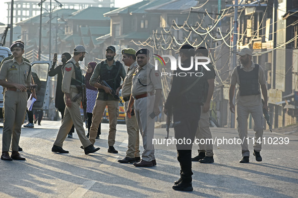 Indian police officers are taking security measures as thousands of Shia Muslims are attending the mourning procession to commemorate the ma...