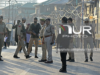 Indian police officers are taking security measures as thousands of Shia Muslims are attending the mourning procession to commemorate the ma...