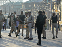 Indian police officers are taking security measures as thousands of Shia Muslims are attending the mourning procession to commemorate the ma...