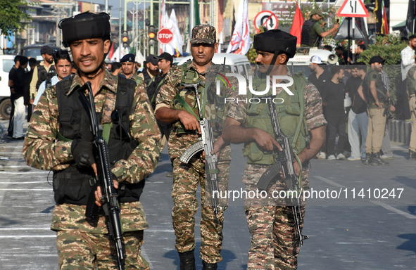 Indian paramilitary soldiers are patrolling the street as thousands of Shia Muslims are attending the mourning procession to commemorate the...