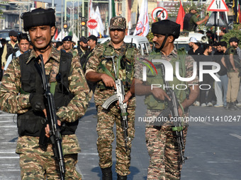 Indian paramilitary soldiers are patrolling the street as thousands of Shia Muslims are attending the mourning procession to commemorate the...