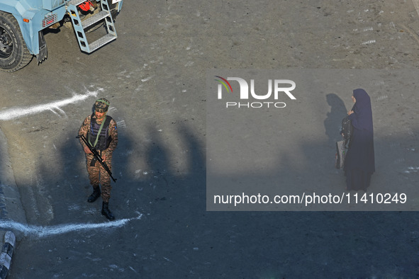 An Indian paramilitary soldier is patrolling the street as thousands of Shia Muslims are attending the mourning procession to commemorate th...