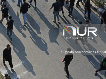 Kashmiri Shia mourners are walking as thousands of Shia Muslims are attending the mourning procession to commemorate the martyrdom of Prophe...