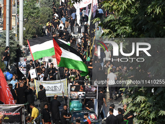 Thousands of Shia Muslims are attending the mourning procession to commemorate the martyrdom of Prophet Muhammad's grandson Imam Hussein (Hu...