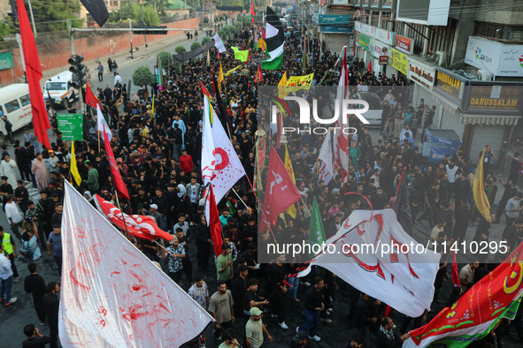 Kashmiri Shiite Muslim mourners are taking part in a Muharram procession on the eighth day of Ashura in Srinagar, Jammu and Kashmir, on July...