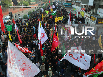 Kashmiri Shiite Muslim mourners are taking part in a Muharram procession on the eighth day of Ashura in Srinagar, Jammu and Kashmir, on July...