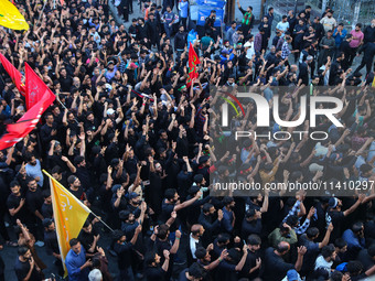 Kashmiri Shiite Muslim mourners are taking part in a Muharram procession on the eighth day of Ashura in Srinagar, Jammu and Kashmir, on July...