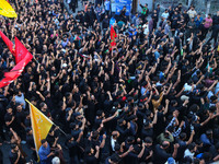 Kashmiri Shiite Muslim mourners are taking part in a Muharram procession on the eighth day of Ashura in Srinagar, Jammu and Kashmir, on July...