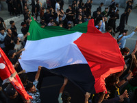 Kashmiri Shiite Muslim mourners are carrying a Palestinian flag and shouting anti-Israel and anti-US slogans as they take part in a Muharram...