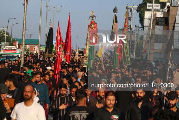 Kashmiri Shiite Muslim mourners are taking part in a Muharram procession on the eighth day of Ashura in Srinagar, Jammu and Kashmir, on July...