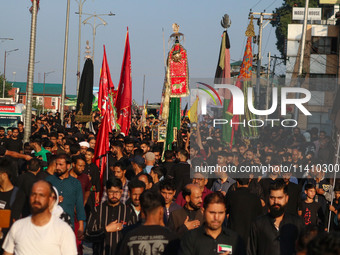 Kashmiri Shiite Muslim mourners are taking part in a Muharram procession on the eighth day of Ashura in Srinagar, Jammu and Kashmir, on July...