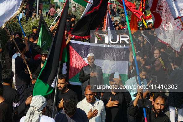 Kashmiri Shiite Muslim mourners are taking part in a Muharram procession on the eighth day of Ashura in Srinagar, Jammu and Kashmir, on July...