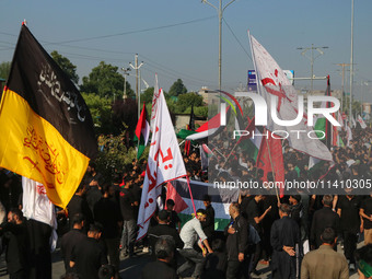 Kashmiri Shiite Muslim mourners are taking part in a Muharram procession on the eighth day of Ashura in Srinagar, Jammu and Kashmir, on July...