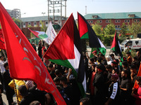 Kashmiri Shiite Muslim mourners are carrying Palestinian flags and shouting anti-Israel and anti-US slogans as they are taking part in a Muh...