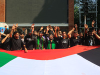 Kashmiri Shiite Muslim mourners are carrying a Palestinian flag and shouting anti-Israel and anti-US slogans as they take part in a Muharram...