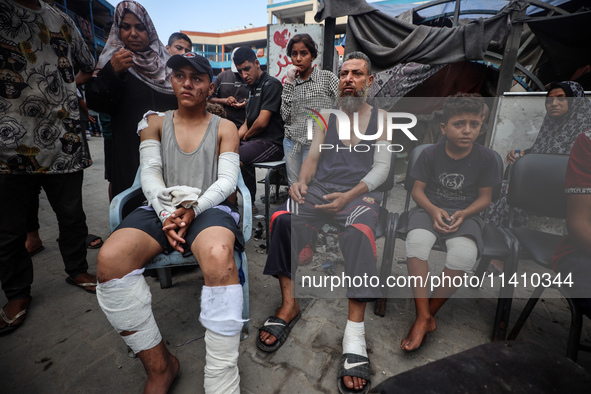 Wounded Palestinians are sitting inside a school run by the UN Relief and Works Agency for Palestine Refugees (UNRWA) that was previously hi...