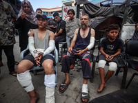 Wounded Palestinians are sitting inside a school run by the UN Relief and Works Agency for Palestine Refugees (UNRWA) that was previously hi...