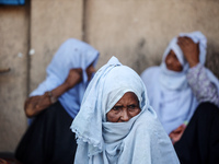 Palestinians are sitting inside a school run by the UN Relief and Works Agency for Palestine Refugees (UNRWA) that was previously hit by Isr...