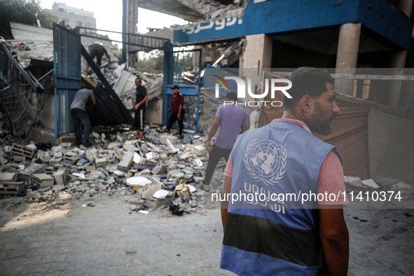 A member of the United Nations is checking the destruction at a school run by the UN Relief and Works Agency for Palestine Refugees (UNRWA)...