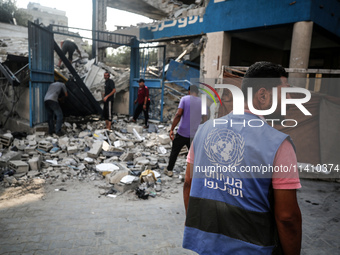 A member of the United Nations is checking the destruction at a school run by the UN Relief and Works Agency for Palestine Refugees (UNRWA)...