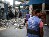 A member of the United Nations is checking the destruction at a school run by the UN Relief and Works Agency for Palestine Refugees (UNRWA)...